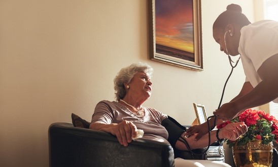 np_Home healthcare nurse checking blood pressure of older woman_5aJ7Q4_free