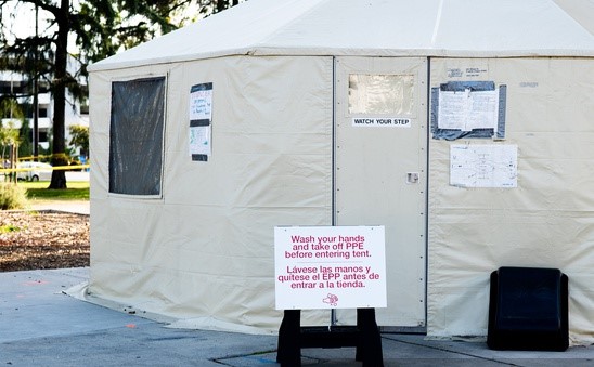 np_Sign with safety instructions in front of testing tent for medical workers at Covid testing site_5Q2jX4_free-1